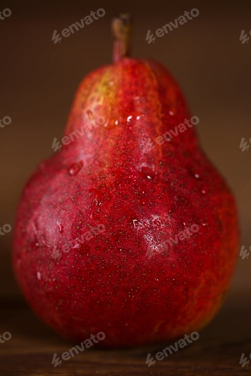 Preview: Pear red color on wooden background.