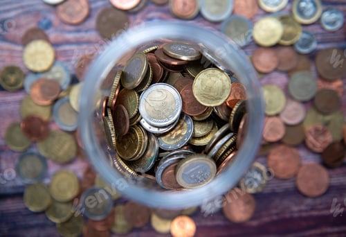 Preview: Pile of euro coins money stack a bottle. Concept of saving money
