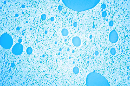 Preview: Macro photo of white shampoo foam on blue background