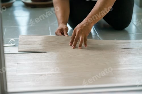 Preview: Vinyl floor installation, worker, DIY at home.