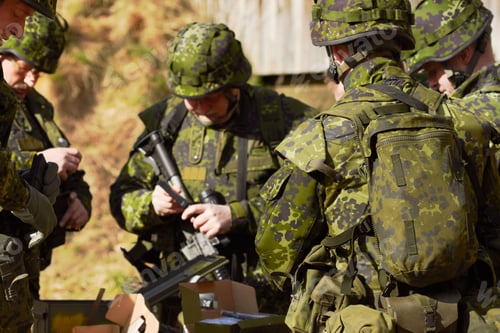 Preview: Always be prepared. Shot of a group of soldiers assembling their weaponry.