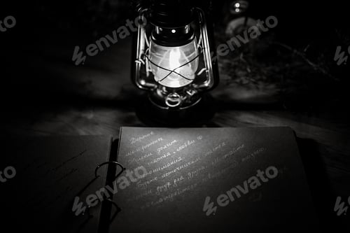 Preview: burning candles on a dark night in a wooden lantern