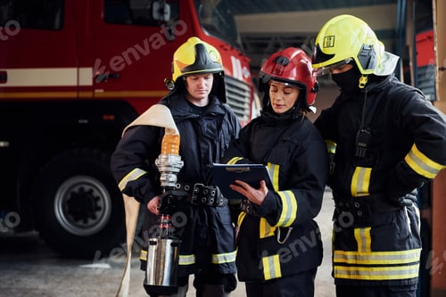 Preview: With notepad. Group of firefighters in protective uniform that is on station