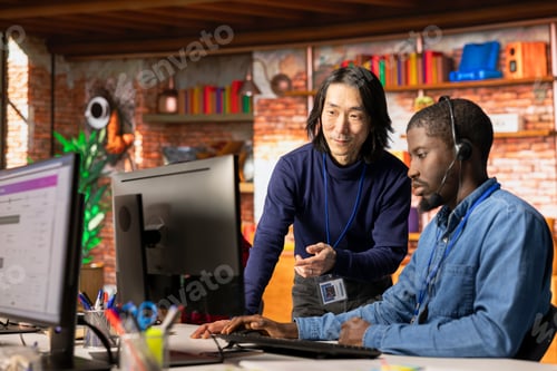Preview: Customer center manager overseeing intern assisting clients