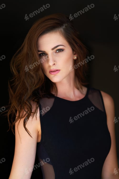 Preview: Studio portrait of an attractive young woman posing against a black background