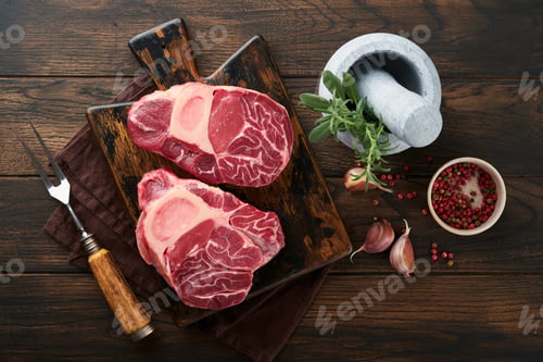 Preview: Osso Buco raw steak meat. Barbecue meat. Raw fresh cross cut veal shank and seasonings pepper, rosem