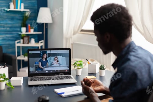 Preview: Man Using Laptop for Virtual Doctor's Appointment