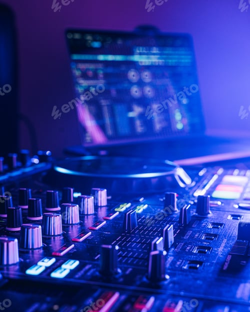 Preview: Professional audio mixing board connected to a laptop, displaying the various knobs and buttons.
