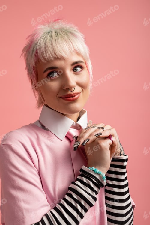 Preview: Joyful young woman with short hair and stylish outfit smiling against a vibrant background