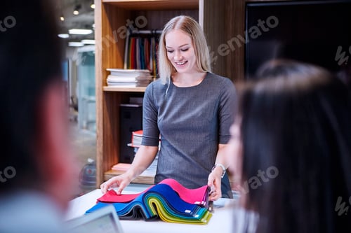 Preview: Woman looking at textile samples smiling