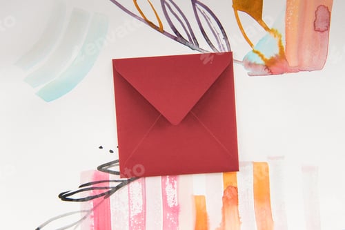 Preview: Top view of closed envelope and bright watercolor painting with floral and abstract elements