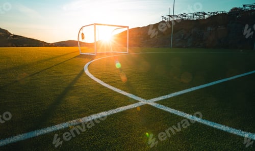 Preview: Wide shot of a football pitch with the sun rays under the beautiful cloudy sky