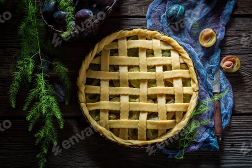 Preview: Rustic and homemade tart with plums on blue cloth