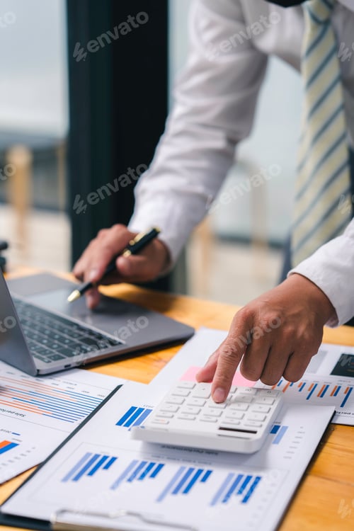 Preview: Accountant doing finance and calculate about cost on the desk at home office, close up hands of acco