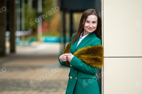 Preview: elegantly dressed business woman at an office building in a financial district