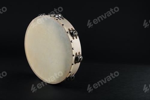 Preview: Tambourine on black background. Space for text