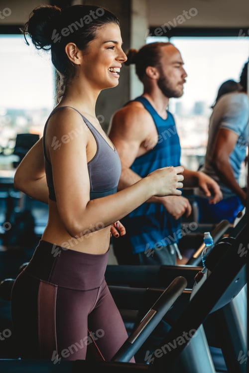 Preview: Group of young people running on treadmills in sport gym
