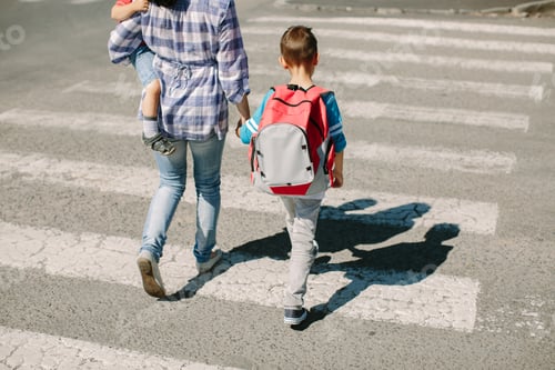 Preview: Mother and her children crossing a road on way to school in the morning