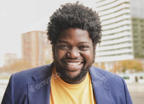 Preview: Young curvy african man smiling on camera outdoor