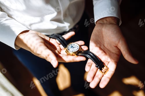 Preview: Stylish men's wrist watch, man is watching the time. . Businessman checking time on his wristwatch.