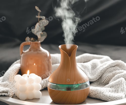 Preview: Spa composition with aroma oil diffuser lamp and candle on a blurred background.