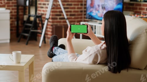 Preview: Relaxed person with modern touchscreen mobile phone having chroma key isolated display