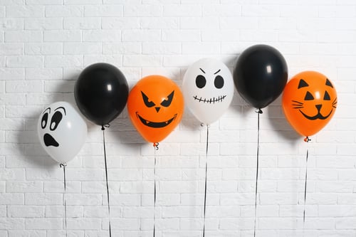 Preview: Color balloons for Halloween party against white brick wall
