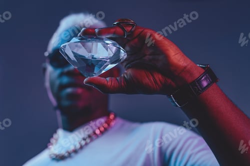 Preview: Rich african man with white hairs holding diamond