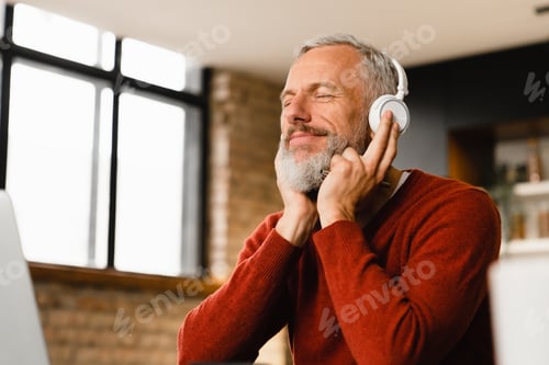 Senior Man Listening to Music with Headphones