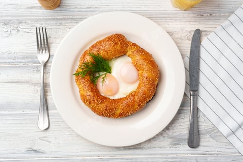 Preview: Turkish bagel simit and fried eggs on plate