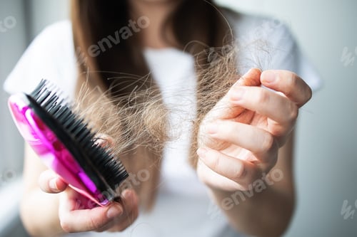 Preview: Close up focus on the hands of a comb with fallen hair. Hair problem