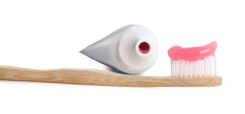 Preview: Wooden brush with toothpaste and tube on white background