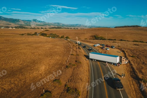 Preview: Aerial shot of an asphalt highway with a small traffic jam in a dry grassland