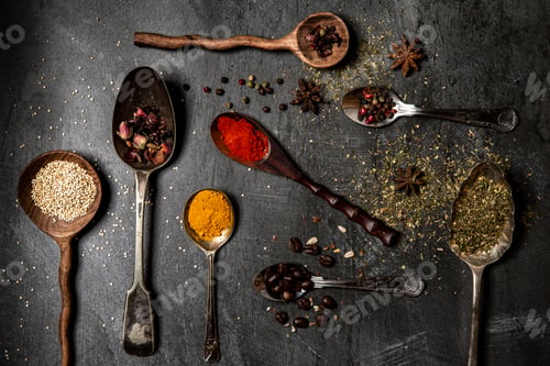 Preview: A symphony of spices artfully arranged on a dark, textured backdrop.