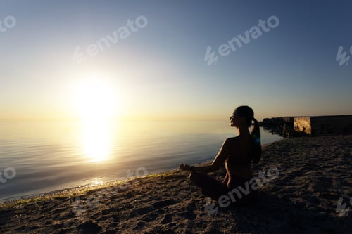 Preview: Woman sitting in lotus pose and meditating