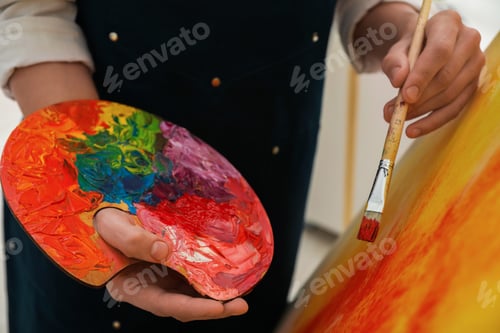 Preview: Man with palette and paintbrush drawing picture indoors, closeup