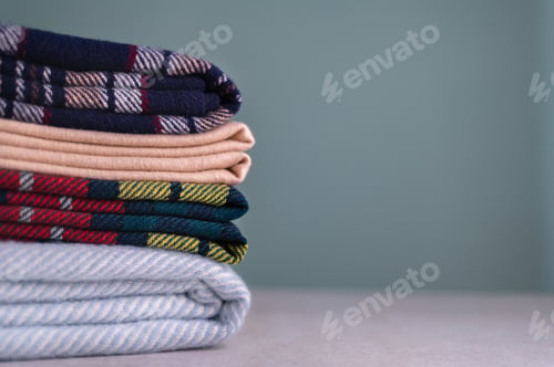 Preview: Stack of woolen checked blankets