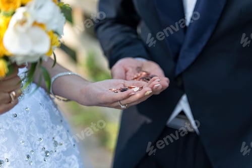 Preview: The bride and groom there with a handful of coins.