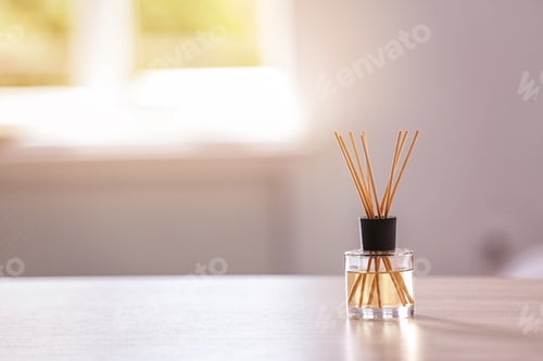 Preview: Aromatic reed air freshener on table against blurred background