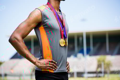 Preview: Athlete posing with gold medals around his neck