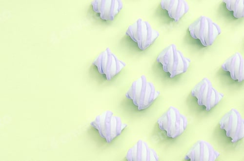Preview: Colorful marshmallow laid out on lime paper background