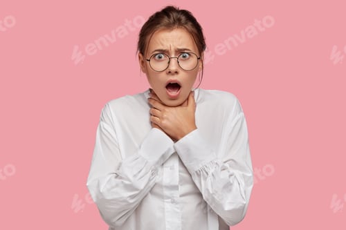 Preview: Horizontal shot of desperate young European woman keeps both hands on neck, suffers from asthmatic f