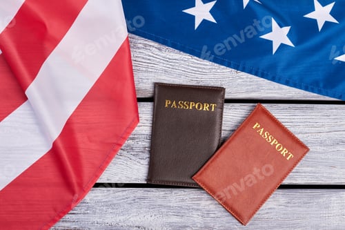Preview: USA flag and two passports, top view.