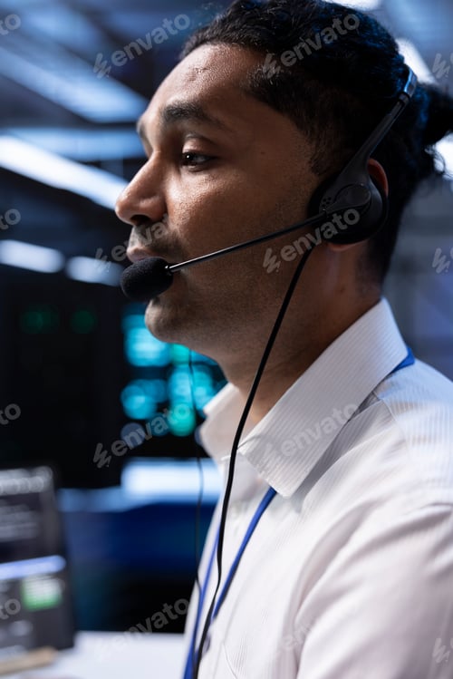 Preview: Worker in high tech server room facility coordinating technicians