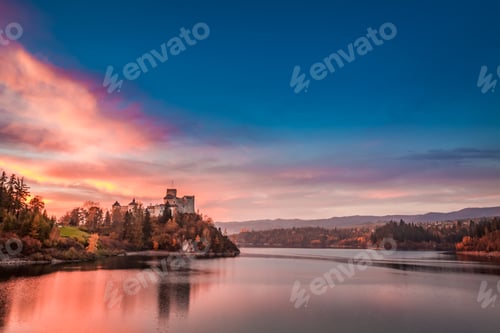 Preview: Wonderful castle by the lake in autumn at sunset
