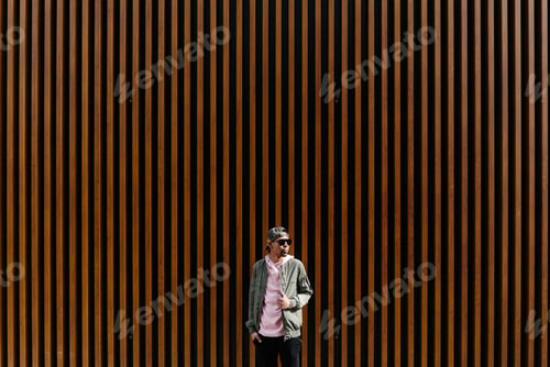 Preview: Portrait of confident young Afro man posing over wooden background