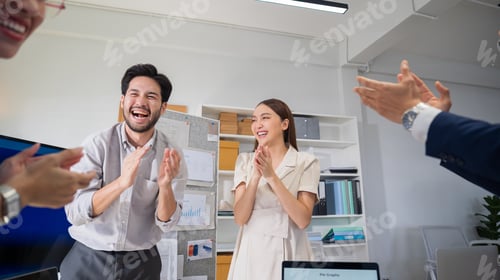 Preview: Asian employees congratulating for achievement with applause in modern office