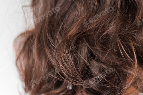 Preview: Close up of curly hair of a brunette woman.