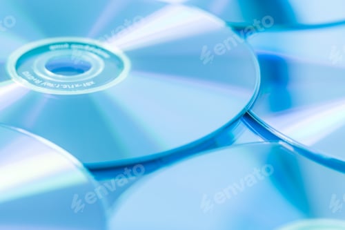 Preview: Stack of CD or DVD in blue tone as background. Soft focus.