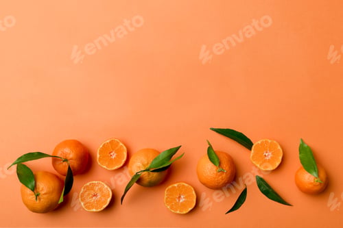 Preview: Many fresh ripe mandarin with green leaves on colored background, top view, space for text